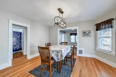 a dining room with a table and chairs at 1 Mi to Dtwn Binghamton Apt with Covered Balcony! in Binghamton