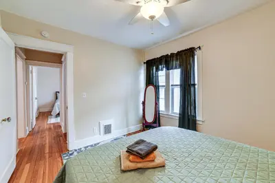 a bedroom with a bed with a mirror on it at 1 Mi to Dtwn Binghamton Apt with Covered Balcony! in Binghamton