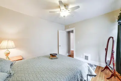a bedroom with a bed and a ceiling fan at 1 Mi to Dtwn Binghamton Apt with Covered Balcony! in Binghamton