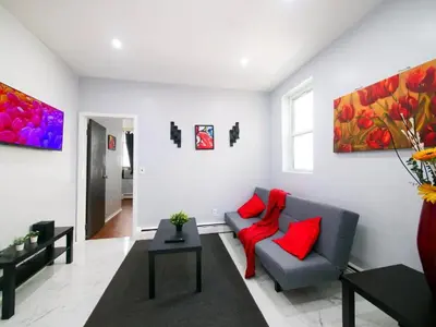 a living room with a couch and red pillows at Sleek one-bedroom abode near NYC in Jersey City