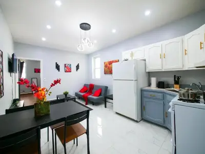 a kitchen with a white refrigerator and a dining room at Sleek one-bedroom abode near NYC in Jersey City