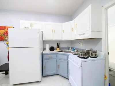 a kitchen with white appliances and a white refrigerator at Sleek one-bedroom abode near NYC in Jersey City