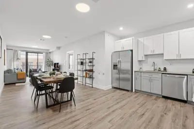 a kitchen and dining room with a table and chairs at Modern Retreat Free Parking 30Min NYC in Bayonne