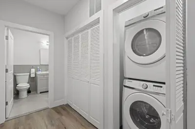a white laundry room with a washer and dryer at Modern Retreat Free Parking 30Min NYC in Bayonne