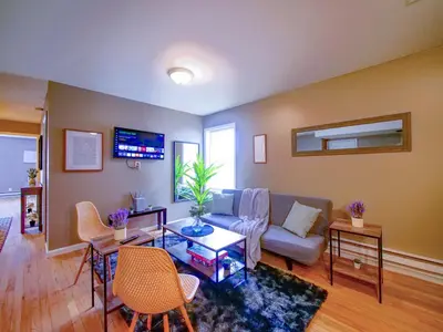 a living room with a couch and a table at Deluxe 2-Bedroom Apt minutes from NYC in Jersey City