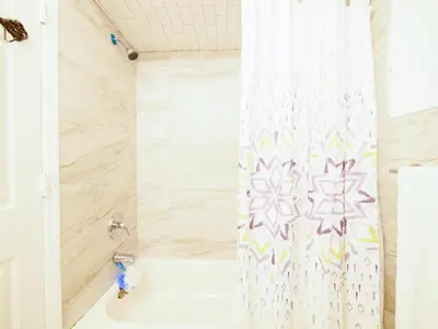 a shower curtain in a bathroom with a tub at Deluxe 2-Bedroom Apt minutes from NYC in Jersey City