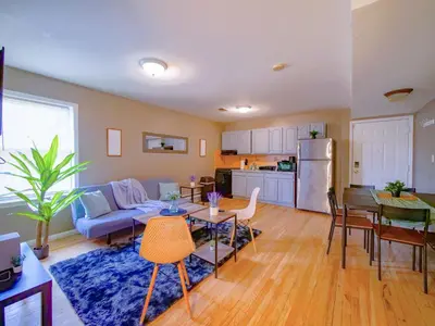 a living room with a couch and a table at Deluxe 2-Bedroom Apt minutes from NYC in Jersey City