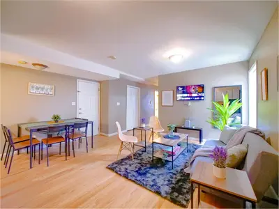 a living room with a couch and a table at Deluxe 2-Bedroom Apt minutes from NYC in Jersey City