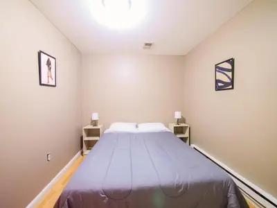 a bedroom with a large bed in a room at Deluxe 2-Bedroom Apt minutes from NYC in Jersey City