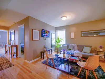 a living room with a couch and a table at Deluxe 2-Bedroom Apt minutes from NYC in Jersey City