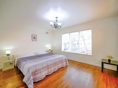 a bedroom with a bed and a large window at Impressive 3bed 2bath apt close to NYC in Jersey City