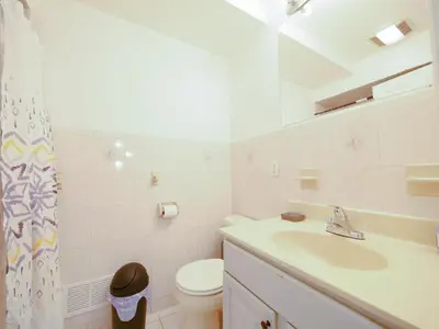 a white bathroom with a sink and a toilet at Impressive 3bed 2bath apt close to NYC in Jersey City