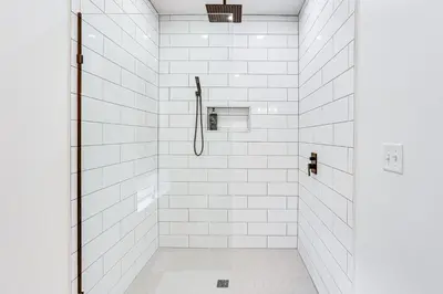 a white bathroom with a shower with white tiles at Walk to the Amish Village Spacious Ronks Getaway! in Ronks