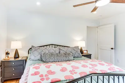 a bedroom with a bed and two night stands at Walk to the Amish Village Spacious Ronks Getaway! in Ronks