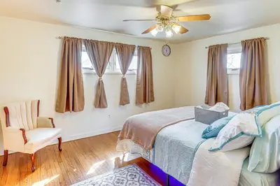 a bedroom with a bed and a ceiling fan at 3 Mi to Berkshire Mall Suburban Stay with Yard! in Sinking Spring
