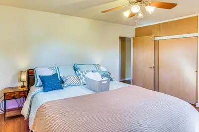 a bedroom with a bed with a ceiling fan at 3 Mi to Berkshire Mall Suburban Stay with Yard! in Sinking Spring