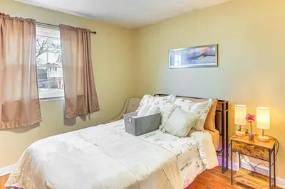 a bedroom with a bed and a window at 3 Mi to Berkshire Mall Suburban Stay with Yard! in Sinking Spring