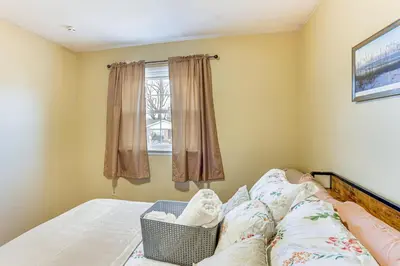 a bedroom with a bed and a window at 3 Mi to Berkshire Mall Suburban Stay with Yard! in Sinking Spring