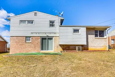 a house with a lawn in front of it at 3 Mi to Berkshire Mall Suburban Stay with Yard! in Sinking Spring