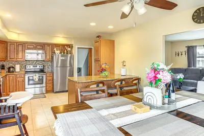 a kitchen and living room with a dining table and a kitchen with at 3 Mi to Berkshire Mall Suburban Stay with Yard! in Sinking Spring