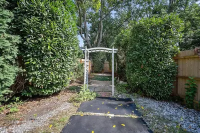 a garden with an archway in a yard at Main Line Manor 3BR with King Beds & Patio & Backyard in Bryn Mawr
