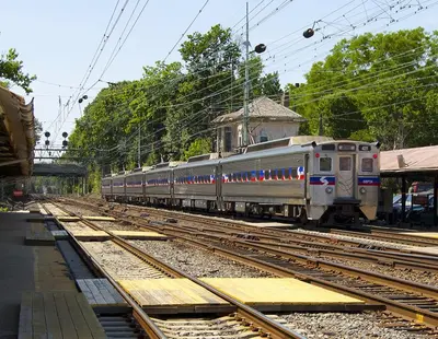 a silver train on the tracks at a train station at Main Line Manor 3BR with King Beds & Patio & Backyard in Bryn Mawr