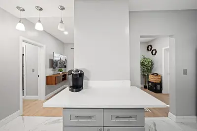 a kitchen with a white counter top in a room at Spacious Luxe Stay Sleeps 16 20 Min to NYC in Bayonne