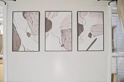 three framed drawings on a wall in a room at Spacious Luxe Stay Sleeps 16 20 Min to NYC in Bayonne