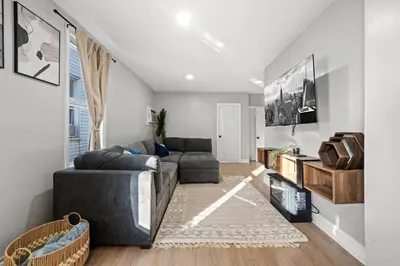 a living room with a couch and a tv at Spacious Luxe Stay Sleeps 16 20 Min to NYC in Bayonne