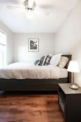 a white bedroom with a bed with pillows on it at Lovely 3BR Homewith free parking-WALK to WP Gate in Highland Falls