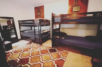 a room with two bunk beds and a rug at Quirky & Cozy Loft SoHo Little Italy - Sleeps 4 in New York