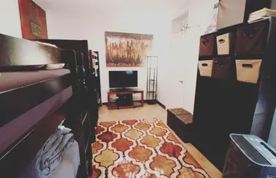a living room with a bed and a rug at Quirky & Cozy Loft SoHo Little Italy - Sleeps 4 in New York