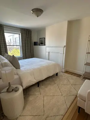 a bedroom with a white bed and a window at NEW! Historic Townhouse-14 min to WTC in Jersey City