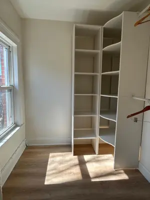 a room with an empty closet with a window at NEW! Historic Townhouse-14 min to WTC in Jersey City