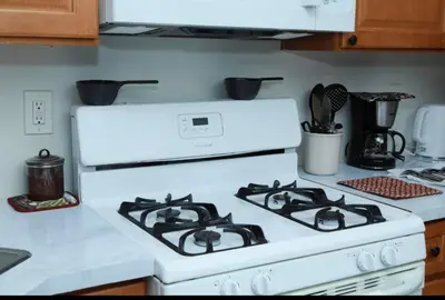 a white stove top oven in a kitchen at Elegant 3BR Home - Near the Prudential Center in Newark