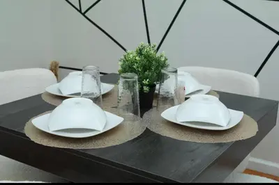 a black table with white plates and glasses at Elegant 3BR Home - Near the Prudential Center in Newark