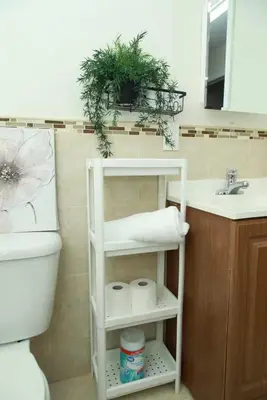 a bathroom with a toilet and a sink at Elegant 3BR Home - Near the Prudential Center in Newark
