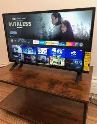 a flat screen tv sitting on top of a wooden table at Private one-bedroom and one-bathroom apartment with private street entrance in convenient area, MetLife Stadium FIFA World Cup 35 minutes away in Perth Amboy