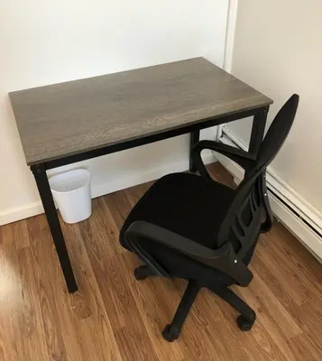 a black desk with a black chair in a room at Private one-bedroom and one-bathroom apartment with private street entrance in convenient area, MetLife Stadium FIFA World Cup 35 minutes away in Perth Amboy
