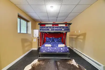 a room with a bunk bed in a room at Secluded Cabin, Jacuzzi, Pool Table, King Bed & Fire Pit in Bushkill