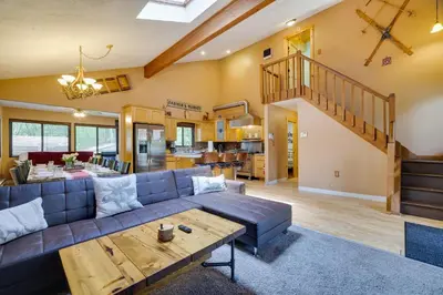 a living room with a couch and a table at Secluded Cabin, Jacuzzi, Pool Table, King Bed & Fire Pit in Bushkill