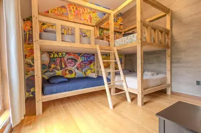 a room with two bunk beds in a house at Pocono River front Home near Camelback Resort in Barton Glen