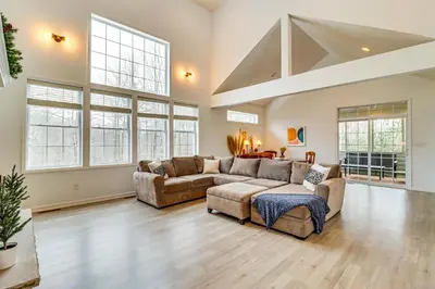 a large living room with a couch and a table at Screened Porch and Fire Pit Spacious Pocono Retreat in Pocono Pines