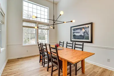 a dining room with a wooden table and chairs at Screened Porch and Fire Pit Spacious Pocono Retreat in Pocono Pines