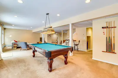 a pool table in the middle of a living room at Screened Porch and Fire Pit Spacious Pocono Retreat in Pocono Pines