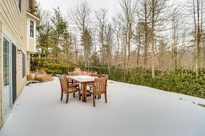 a patio with a table and chairs on it at Screened Porch and Fire Pit Spacious Pocono Retreat in Pocono Pines