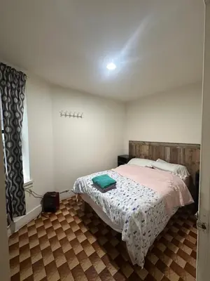 a bedroom with a bed in a room with a window at AL Shami 408 in New York