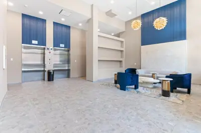 a lobby with blue chairs and a couch at 10 mins to CenterCity, With Queen Bed, Views from RT! in Philadelphia