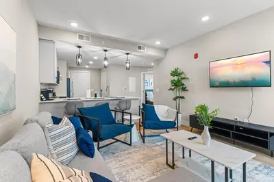 a living room with a couch and a table at 10 mins to CenterCity, Sleeps 6, With Rooftop Views! in Philadelphia