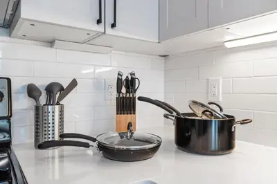 a kitchen counter with a pot and a pan and utensils at 5 mins to Fillmore! Queen Bed, Rooftop, NorthernLibs! in Philadelphia